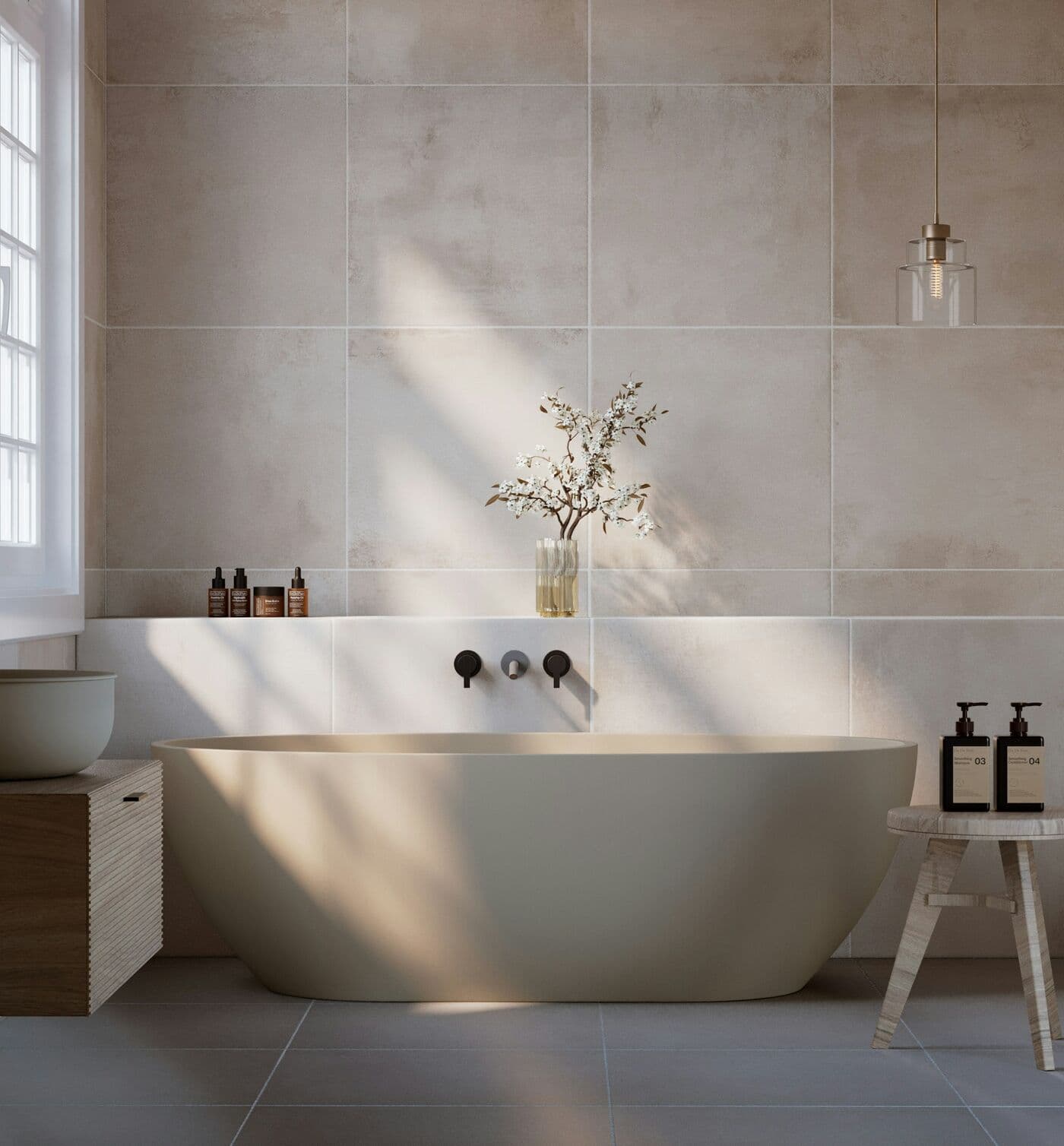 A calm pale bathroom with a freestanding bath and wall-mounted taps