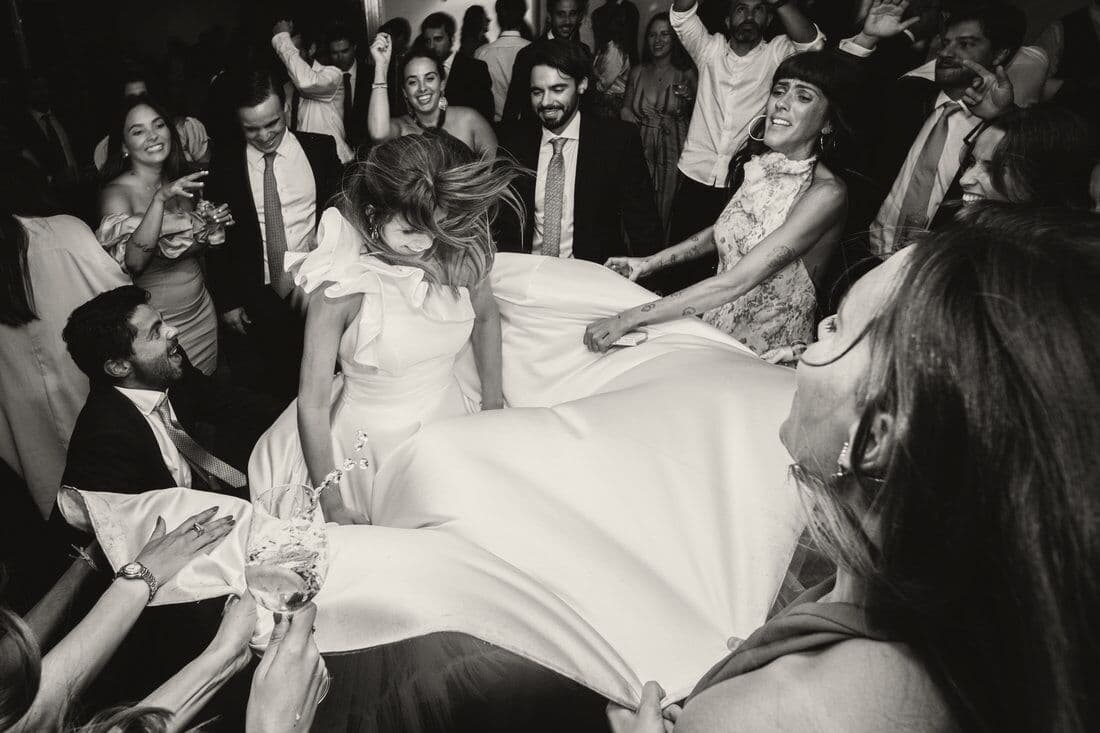 Guests lifting the bride on the dance floor