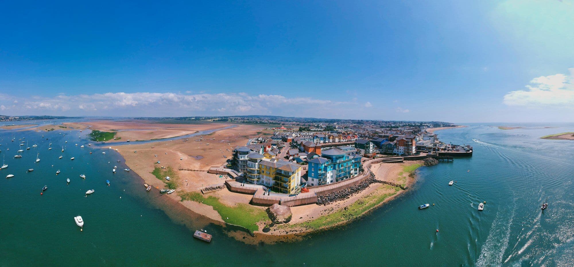 The Exe estuary from the air: a sandy point of town, moored boats and the open water beyond