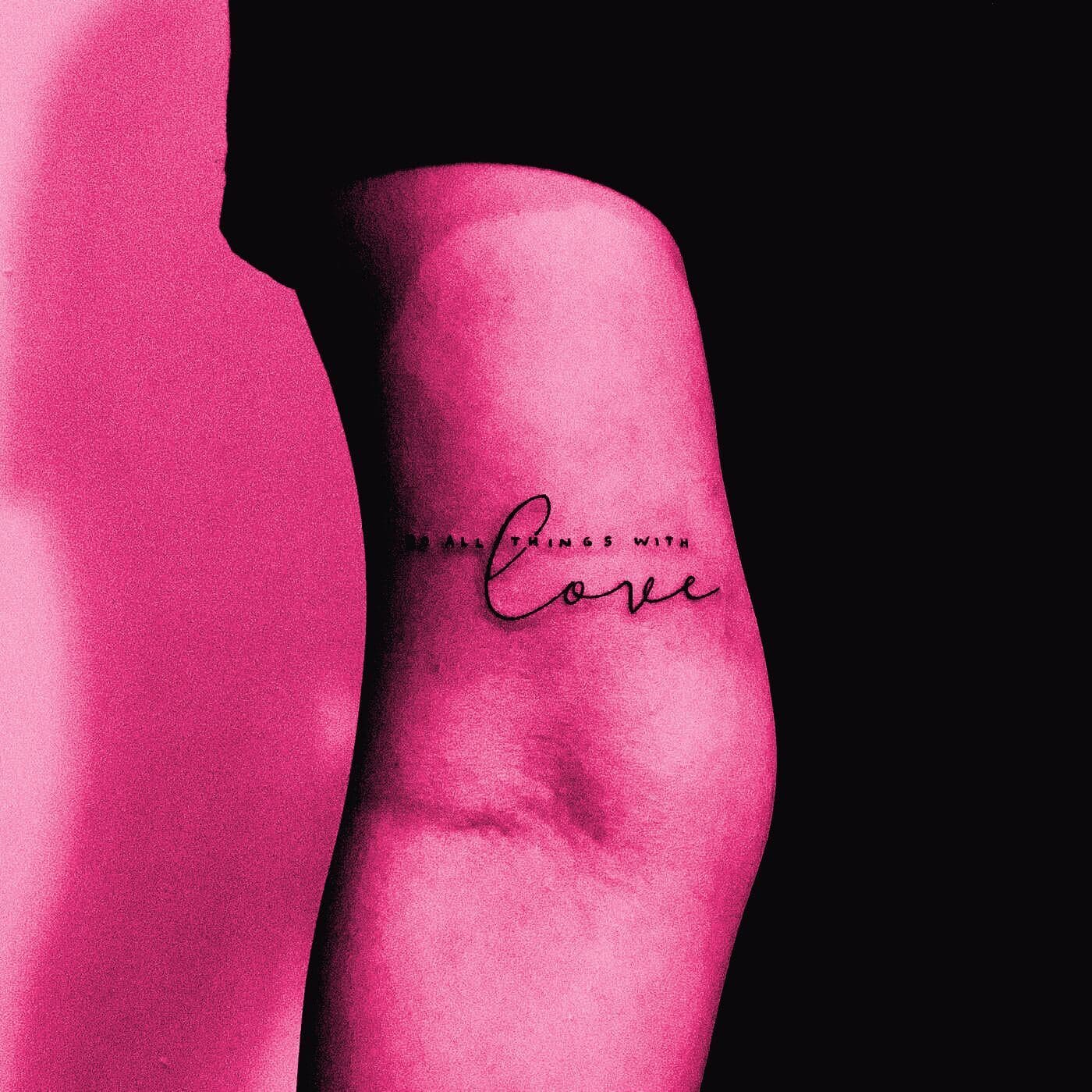 A small handwritten script tattoo on a forearm