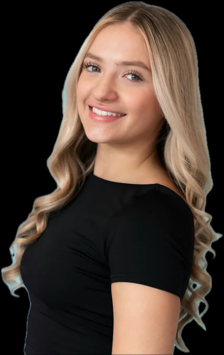 Smiling woman with long, loose honey-blonde waves, wearing a black T-shirt