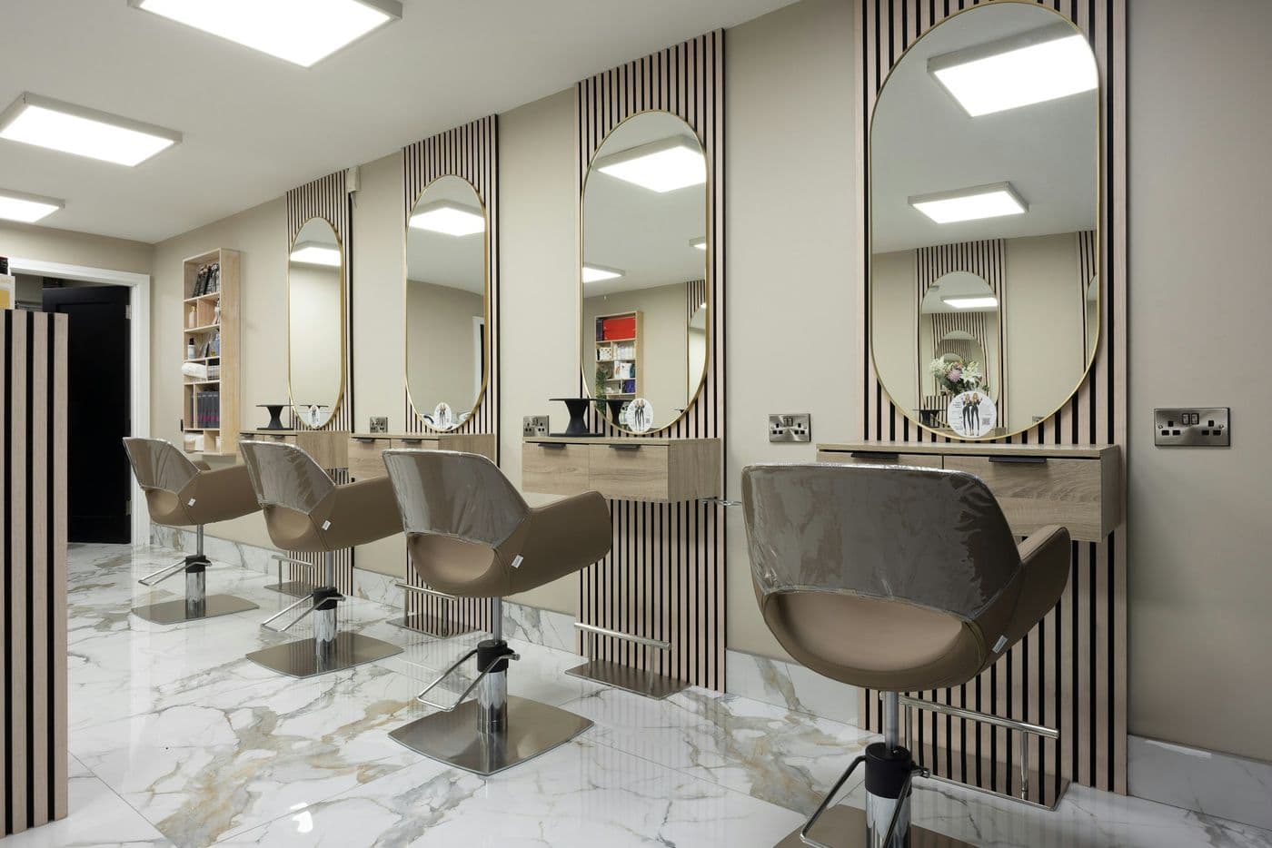 Bright salon interior with arched mirrors, timber slat panels and marble floor