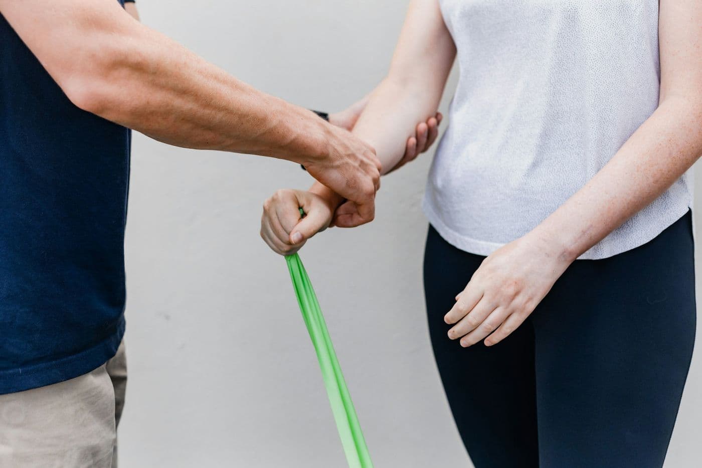 A physiotherapist guiding a patient through a resistance band exercise
