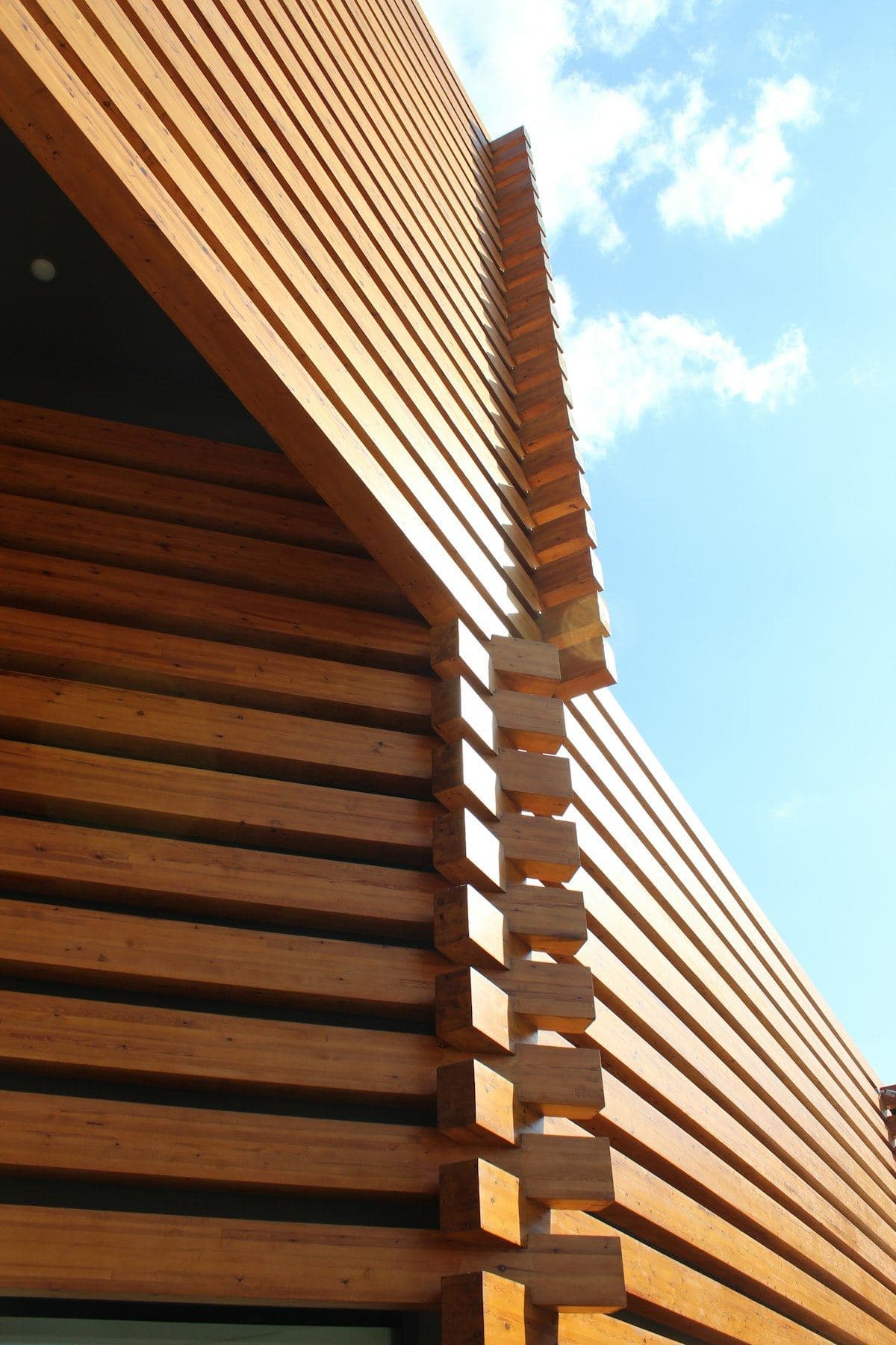 Close-up of horizontal timber boards against a blue sky
