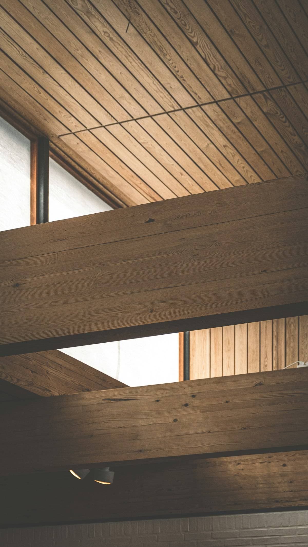 A timber-lined ceiling with a deep rooflight bringing in daylight