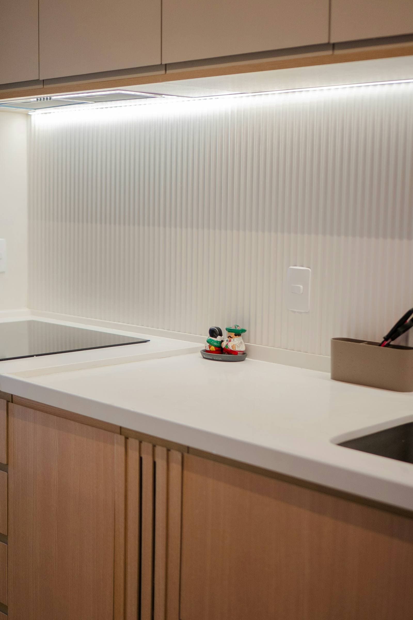 Fluted oak base units under a white quartz worktop